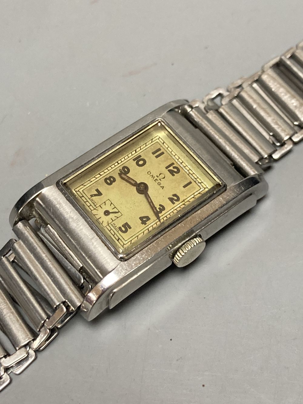 A gentlemans 1940s? stainless steel Omega manual wind wrist watch, with rectangular Arabic dial and subsidiary seconds,